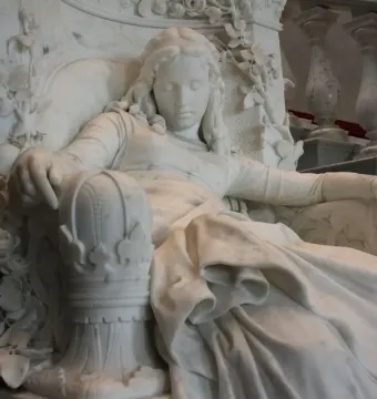 Sleeping Beauty marble sculpture of a resting woman in an ornate carved chair