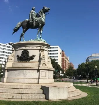 The George Henry Thomas equestrian statue on a stone pedestal in a grassy park.