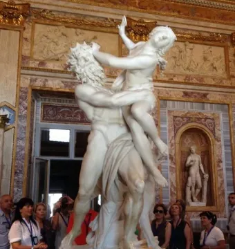 The Rape of Proserpina marble sculpture showing a bearded man lifting a resisting woman in a dramatic struggle.