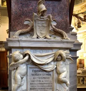 Tomb of Ferdinand van den Eynde with winged putti holding a draped banner above an inscribed marble plaque.