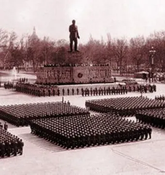 Stalin Monument overlooking a large parade formation in a public square.