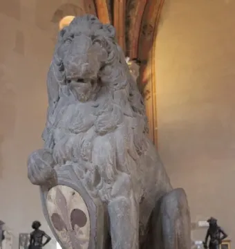Marzocco, a stone lion sculpture holding a shield with a fleur-de-lis emblem