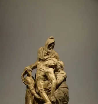 Michelangelo’s The Deposition marble sculpture showing the dead Christ supported by three robed figures.