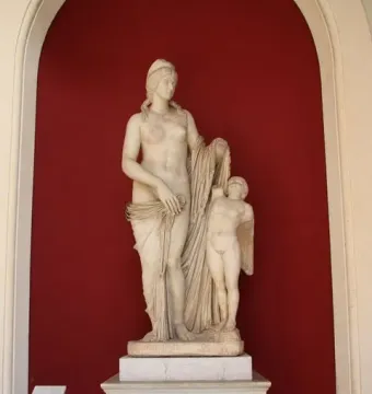 Venus Felix marble statue with a draped female figure beside a small winged child figure missing its head.