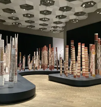 Aboriginal Memorial installation with decorated hollow logs arranged in a gallery