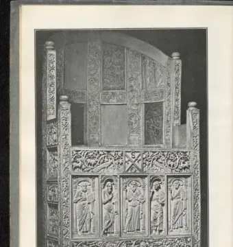 Throne of Maximian with a high curved back and carved relief panels showing robed figures and decorative motifs.