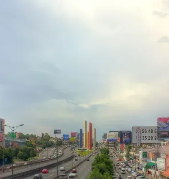 Torres de Satélite colorful towers rising beside a busy multi-lane highway.