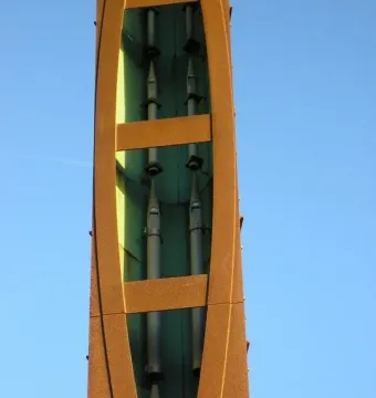Interior detail of the Blackpool High Tide Organ showing upside-down metal pipes inside a reddish-brown structure.