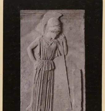 Stone relief of Mourning Athena, showing a helmeted female figure with her head bowed beside a tall marker.