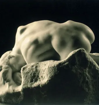 Rodin’s Danaid, a marble nude female figure bent over a rough stone base with her head resting against it.