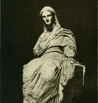 The Demeter of Knidos, a heavily draped seated statue with a tilted head and missing arms, resting on a block-like support and pedestal.