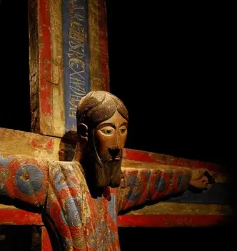 Batlló Majesty wooden Christ on the cross with painted red, blue, and gold details.