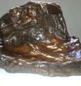 Illusions Received by the Earth, a dark bronze sculpture of two intertwined nude bodies melting into a rocky base.
