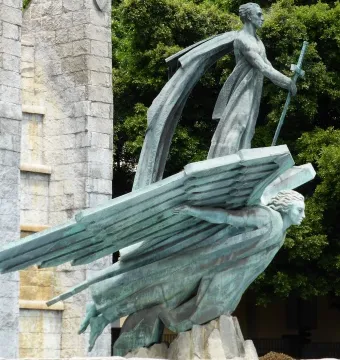 Monumento del Ángel bronze sculpture with a standing figure holding a sword above a winged figure in Santa Cruz de Tenerife.
