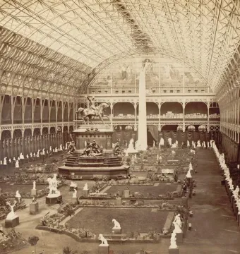 Dom Pedro I equestrian statue on a tall pedestal in a vast glass-and-iron exhibition hall, surrounded by smaller sculptures.