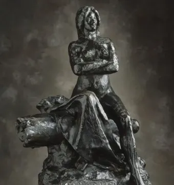The Resistance sculpture of a nude woman seated with crossed arms and an upward gaze.