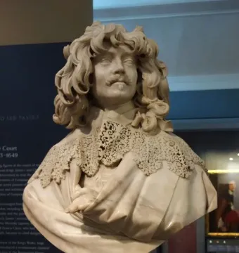 Bust of Thomas Baker with curly hair, a mustache, and an elaborate lace collar.
