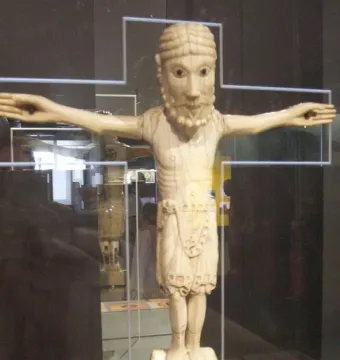 Carrizo Christ, a carved figure of Christ with outstretched arms, beard, braided hair, and a waist garment.