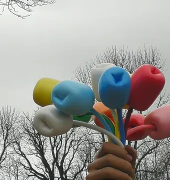 Bouquet of Tulips sculpture showing a giant hand holding colorful tulip-like forms against an overcast sky.