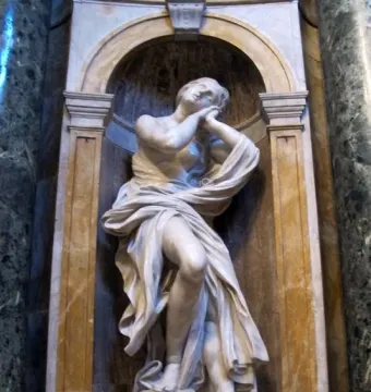 Saints Jerome and Mary Magdalen in white marble, shown in an ornate arched niche with the figure in a contemplative pose.