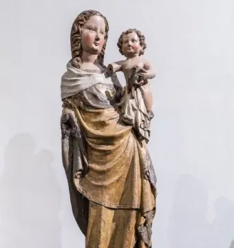Friesentor Madonna, a weathered painted wooden sculpture of the Madonna holding the infant Jesus on her hip.