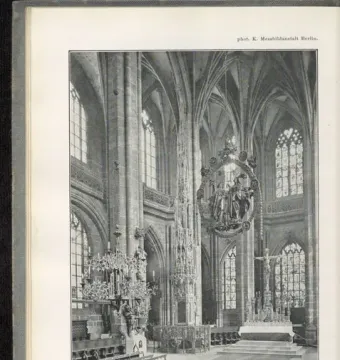 Angelic Salutation, an ornate oval sculpture with carved figures hanging above the church altar.