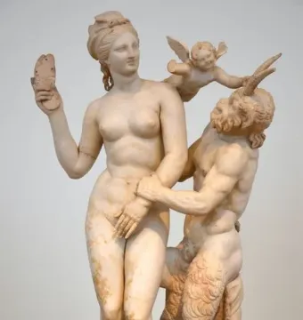 Marble sculpture of Aphrodite, Pan and Eros, with a nude woman resisting Pan as Eros pushes him away.