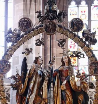 Angelic Salutation carved wooden sculpture with an angel and a woman inside an ornate circular frame