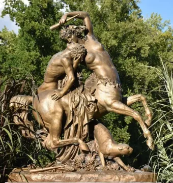 Centauress and Faun bronze sculpture outdoors among trees and tall grasses
