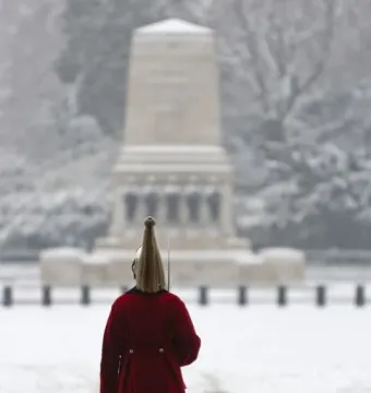 A guardsman stands in the snow facing the Guards Memorial in Whitehall.