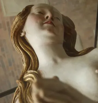 Detail of a wooden sculpture of Mary Magdalene.