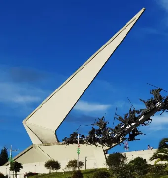 Vargas Swamp Lancers monument with white triangular structure and dark horsemen charging uphill