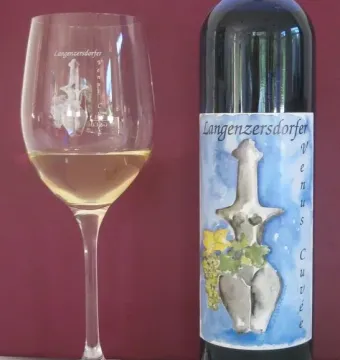 Wine bottle and glass featuring the Venus of Langenzersdorf on the label and etched onto the glass