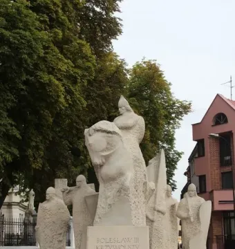 Bolesław III Wrymouth Monument showing a stone equestrian sculpture group with armed companions and an inscribed pedestal.