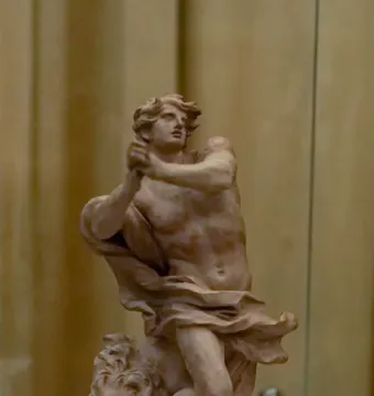 Bernini’s Daniel and the Lion sculpture model showing a muscular figure with raised arms standing over a crouching lion.