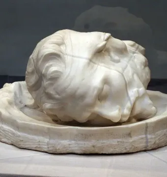 Stone sculpture of the head of Saint John the Baptist resting in a shallow basin