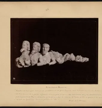 Trisomatos Typhon sculpture with three conjoined bearded male torsos and a coiled serpentine lower body.