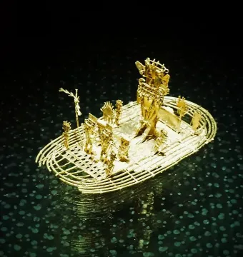 The Muisca Raft sculpture shown as a golden miniature raft with several figures and a taller central figure.