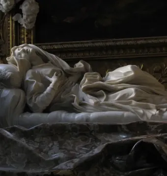 Ecstasy of Blessed Ludovica Albertoni by Bernini, a white marble figure reclining on a sculpted bed with her head tilted back and hands on her chest.