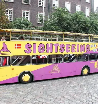 Sightseeing bus with a Little Mermaid graphic and Danish flag on the side