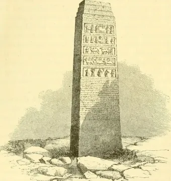 The Black Obelisk shown as a tall tapering monument with carved relief bands and inscriptions on its lower sections.