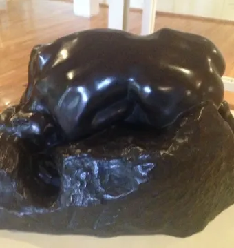 Rodin’s Danaid sculpture showing a bent female figure pressed over a rocky base