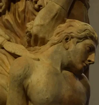 Marble sculpture of The Sacrifice of Isaac showing a raised hand holding a dagger above a bowed, bare-chested figure.
