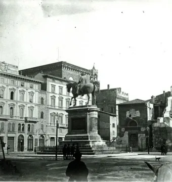 Victor Emmanuel II Monument seen from a city square, with a rider on horseback atop a tall stone pedestal.