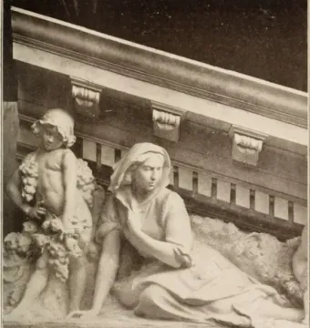 Marble relief from Apotheosis of Democracy showing a child holding grapes beside a reclining draped woman.