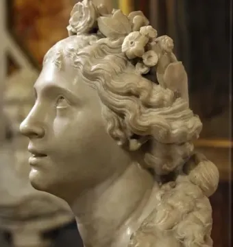 Blessed Soul, a white marble bust of a young woman in profile with wavy hair and floral ornaments, gazing upward.