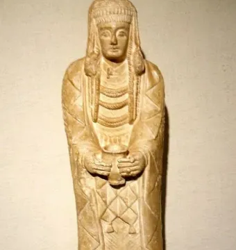 Lady of Cerro de los Santos stone statue holding a small vessel with both hands