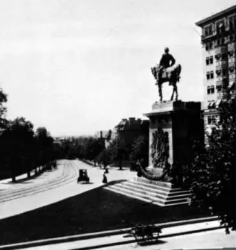 Major General George B. McClellan equestrian statue on an ornate stepped base beside a street with tram tracks.