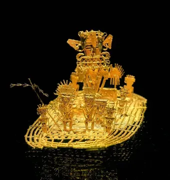 Muisca Raft with stylized gold figures on a raft-shaped base, featuring a larger figure with an elaborate headdress at the back.