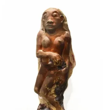 Oviri, a reddish-brown sculpture of a nude female figure standing over a wild animal